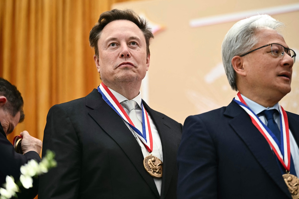 (L-R) SpaceX CEO Elon Musk and US' CEO Of nvidia Jensen Huang react after being awarded the National Medal of Science during the "Golden Age of American Innovation Summit" at the Institute of Peace in Washington, DC, on October 8, 2026. (Photo by Kent NISHIMURA / AFP)