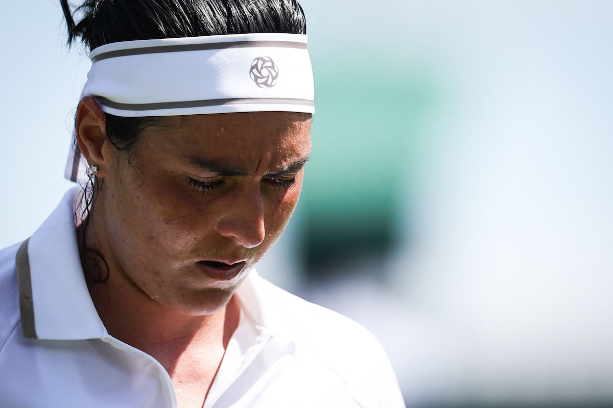 Tunisia's Ons Jabeur reacts as she plays against Bulgaria's Viktoriya Tomova during their women's singles first round tennis match on the first day of the 2025 Wimbledon Championships at The All England Lawn Tennis and Croquet Club in Wimbledon, southwest London, on June 30, 2025. (Photo by HENRY NICHOLLS / AFP) / RESTRICTED TO EDITORIAL USE