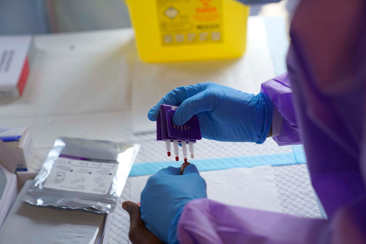 A health worker collects a blood sample from a patient before administering a dose of the Tumaini vaccine against Ebola virus, in Ituri, Congo, Friday, Oct. 23, 2026. (AP Photo/Dieudonne Dirole)